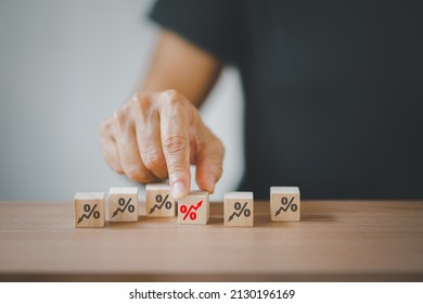 senior hand choosing red increasing percent among black decreasing percent on wooden desk, business development, increasing interest, payment, profit concept - Shutterstock ID 2130196169