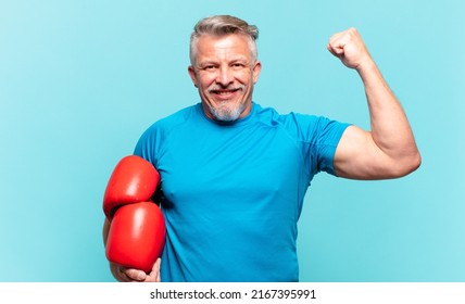 senior handsome man with boxing gloves and training  - Powered by Shutterstock