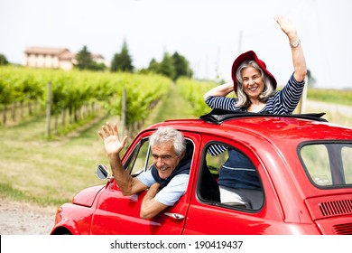 Senior happy couple driving vintage car - Powered by Shutterstock