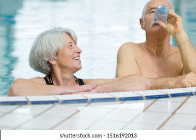 senior happy couple in swimming pool - Powered by Shutterstock