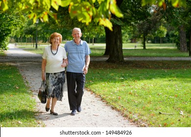 Senior Happy Couple Walking In The Park  