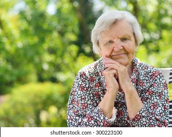 Senior happy woman smiling in garden.MANY OTHER PHOTOS FROM THIS SERIES IN MY PORTFOLIO.