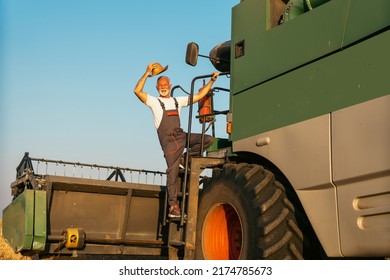 An senior Harvester machine driver climbing into a cab to harvest his wheat field. Farmer getting in combine on ladder holding railing. Smiling senior agronomist looking at camera.
 - Powered by Shutterstock