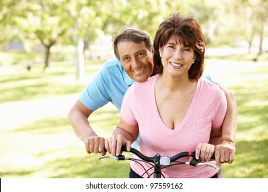 Senior Hispanic Couple With Bike