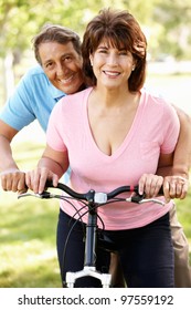 Senior Hispanic Couple With Bike