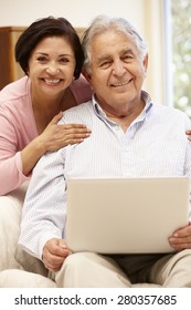 Senior Hispanic Couple With Laptop