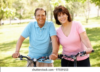 Senior Hispanic Couple On Bikes