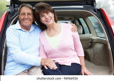 Senior Hispanic Couple Outdoors With Car