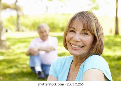 Senior Hispanic Couple Relaxing In Park