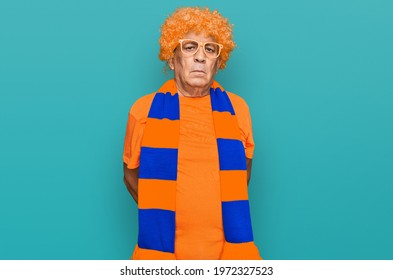 Senior Hispanic Man Football Hooligan Cheering Game With Serious Expression On Face. Simple And Natural Looking At The Camera. 