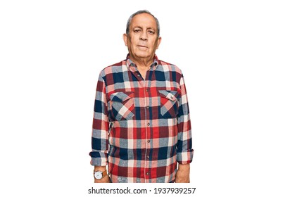 Senior Hispanic Man Wearing Casual Clothes With Serious Expression On Face. Simple And Natural Looking At The Camera. 