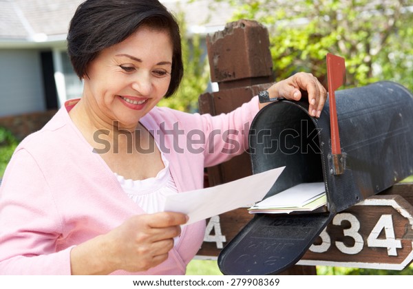 Senior Hispanic Woman\
Checking Mailbox