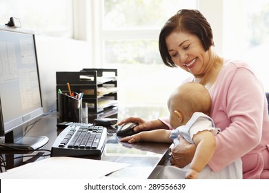 Senior Hispanic woman with computer and baby