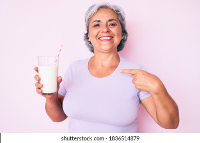 Senior Hispanic Woman Holding Glass Of Milk Pointing Finger To One Self Smiling Happy And Proud 