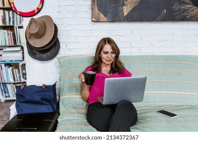 Senior Hispanic Woman Middle Age Working At Home In Sofa Or Home Office In Mexico Latin America
