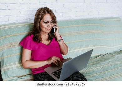 Senior Hispanic Woman Middle Age Working At Home In Sofa Or Home Office In Mexico Latin America
