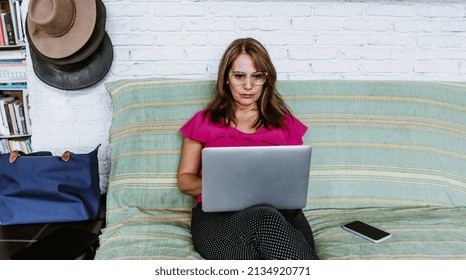 Senior Hispanic Woman Middle Age Working With Computer At Home In Sofa Or Home Office In Mexico Latin America
