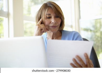 Senior Hispanic Woman Working In Home Office