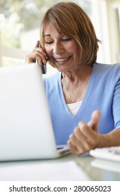 Senior Hispanic Woman Working In Home Office