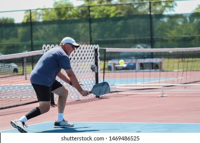 A Senior Hits A Pickleball Shot During A Tournament