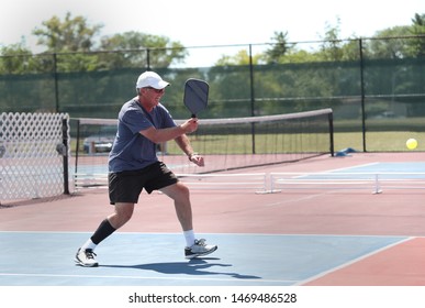 A Senior Hits A Pickleball Shot During A Tournament