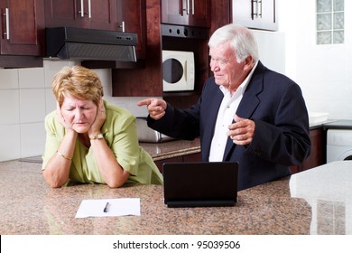 senior husband pointing fingers at his wife - Powered by Shutterstock