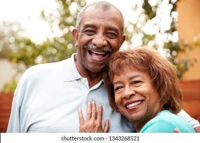 Senior husband and wife embracing, smiling to camera, close up - Powered by Shutterstock