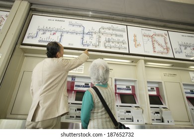 Senior Husband And Wife Looking At Route Map Of Train