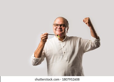 Senior Indian Asian Man Eating Fresh Green Salad. Mature Male Male Having Healthy Snack, Healthcare, Diet Concept