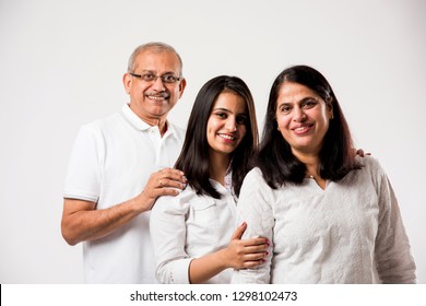 Senior Indian couple with young adult girl standing isolated over white background. selective focus