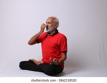 senior Indian man in yoga pose.