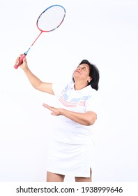 Senior Indian Woman Posing With Badminton Racket Indoor