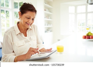 Senior Indian Woman Using Digital Tablet At Home