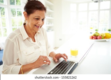 Senior Indian Woman Using Laptop At Home