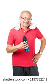 Senior Indian/asian Man Drinking Fresh Water While Or After Weight Training Or Gym, Keeping Himself Dehydrated