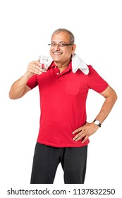 Senior Indian/asian Man Drinking Fresh Water While Or After Weight Training Or Gym, Keeping Himself Dehydrated