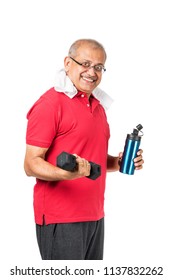 Senior Indian/asian Man Drinking Fresh Water While Or After Weight Training Or Gym, Keeping Himself Dehydrated