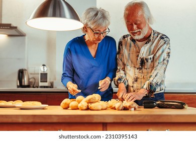 Senior interracial married couple preparing the dinner together in the kitchen - Powered by Shutterstock