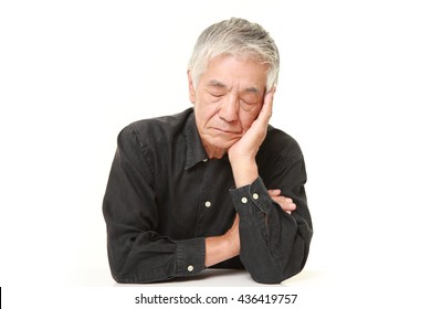 Senior Japanese Man  In A Black Shirts Sleeping On The Table