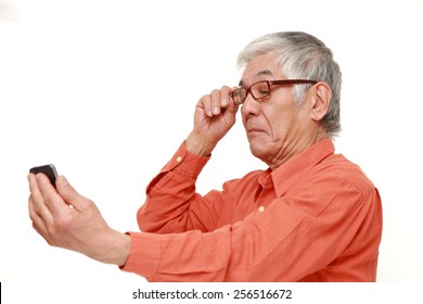 Senior Japanese Man With Presbyopia