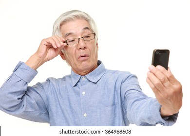 Senior Japanese Man With Presbyopia