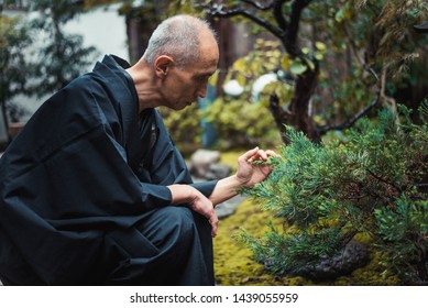 Senior japanese man taking care of his garden