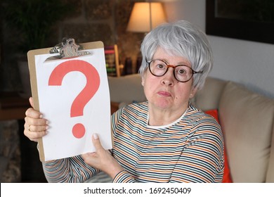 Senior Lady Holding Question Mark