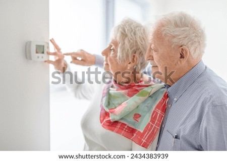 Similar – Caregiver looking through the window with elderly patient in wheelchair