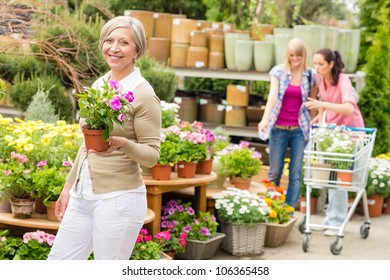 Senior Lady Shopping For Flowers At Garden Centre Smiling