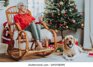 Senior lady using tablet in comfortable rocking chair stock photo - Powered by Shutterstock