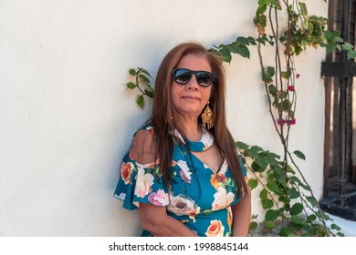 Senior Latina Woman With Long Hair Wearing A Dress