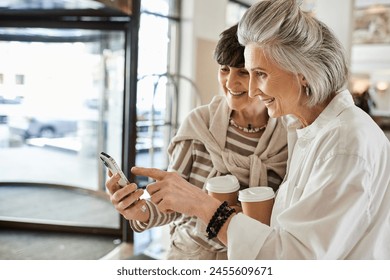 A senior lesbian couple sharing a tender moment together in a hotel. - Powered by Shutterstock