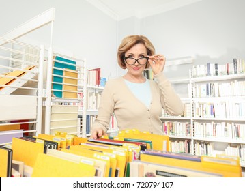 Senior Librarian Working At School Library