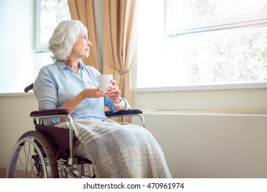 Senior lonely woman in wheelchair - Powered by Shutterstock